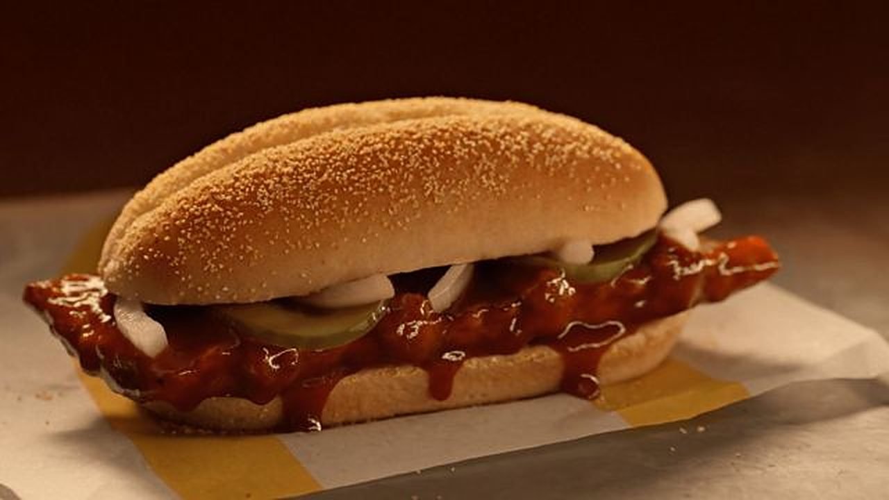 McDonald's McRib sandwich with BBQ sauce, slivered onions and pickles on a homestyle roll